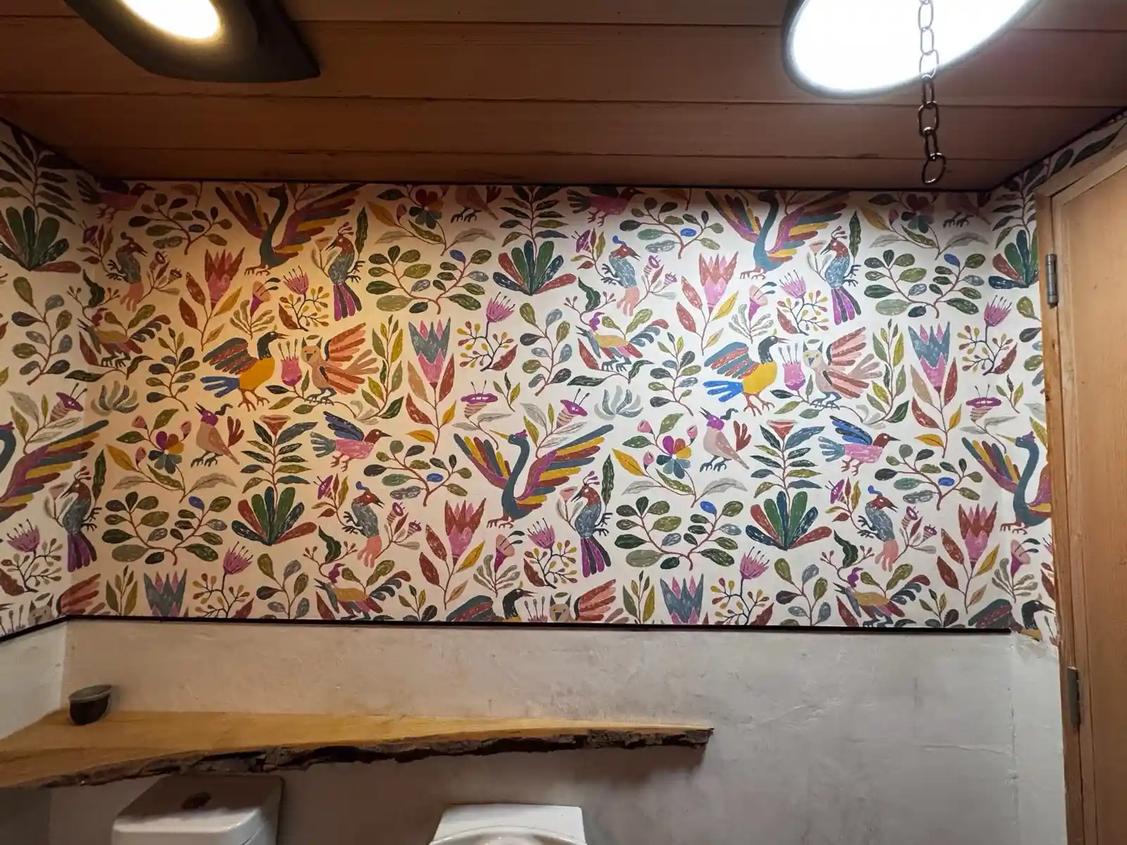 A light-toned interior with a repeating wallpaper pattern